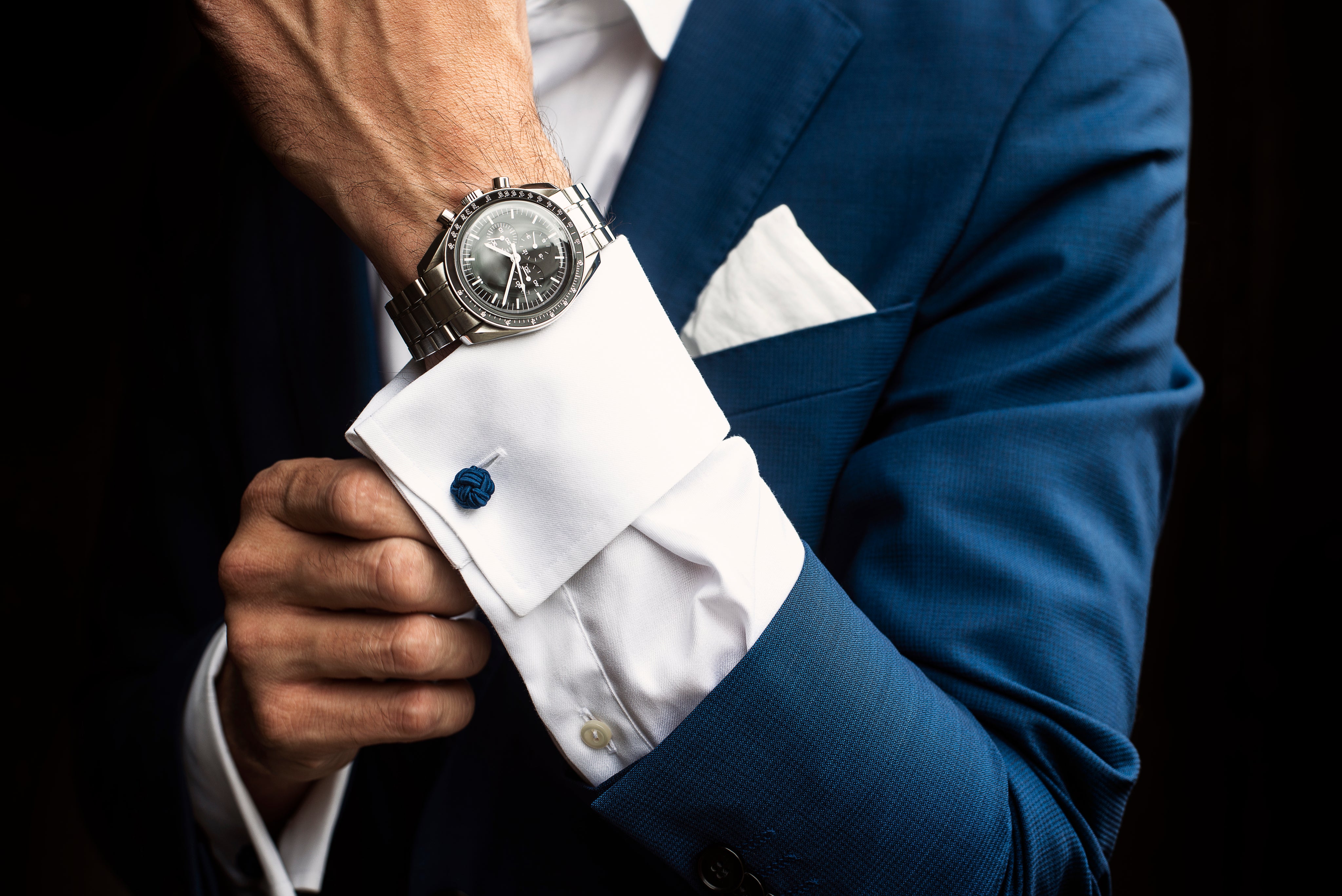 man-adjusts-his-shirt-cuffs-below-watch.jpg